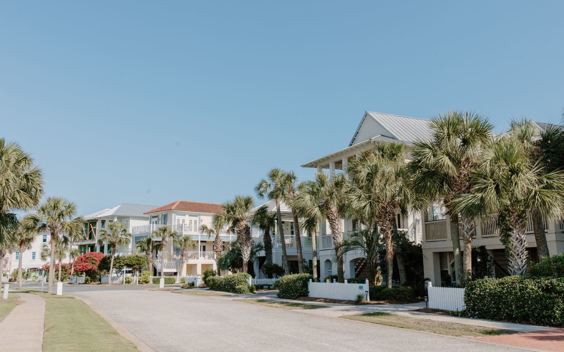 street view of houses with palm trees in the front yards